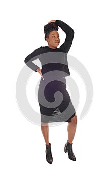 An African woman standing in a black dress waist up