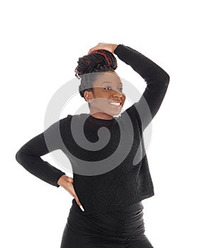 An African woman standing in a black dress waist up