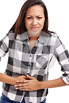 African woman and stomach pain in studio with upset or hurt, bellyache or digestive disorder. Female person, backdrop