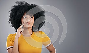 African woman, thinking and ideas in studio for university decision, confused or question on gray background. Student or