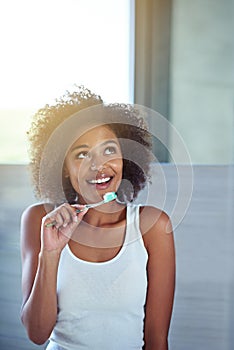 African woman, toothbrush and happy in bathroom for oral wellness, health and benefits for mouth in home. Girl, person