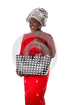 African woman in traditional clothing with tote bag.Isolated