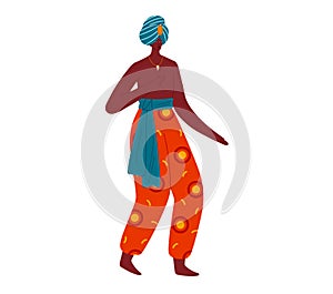 African woman in traditional dress walking confidently. Ethnic fashion and elegant posture. Cultural attire and pride