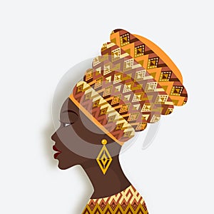 African woman in turban and earrings in profile