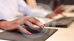 African woman is typing on the keyboard. Close-up of female hands of an office worker.