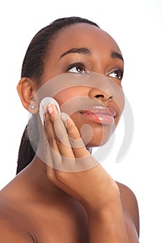 African woman uses cosmetics cleansing facial pad photo