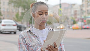 African Woman using Digital Tablet Outdoor