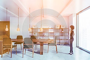 African woman in white and brown dining room