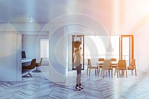 African woman in white dining room and home office