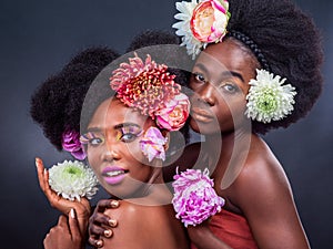 African, women and flowers in makeup with daisy and art in dark background, studio and mockup. Floral, cosmetics and