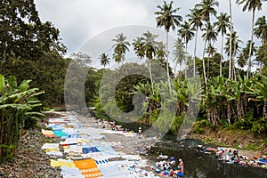 African women washing clothes on a river in Sao Tome