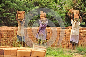 African women at work carrying bricks