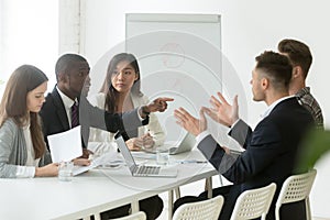 African worker disputing disagreeing with caucasian colleague du