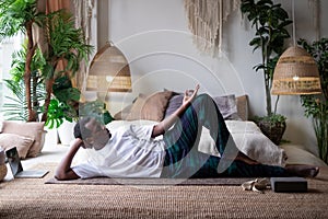 African yoga man doing anantasana pose working out at home