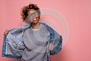 African young curly woman in jeans dancin