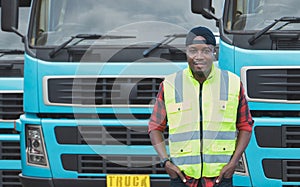African Young Man owner Truck Driver happy Smiling confident near lorry