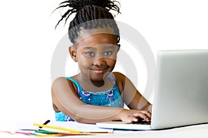 African youngster sitting with hands on keyboard.