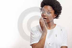 Africanamerican woman trying to close her mouth while sneezing photo