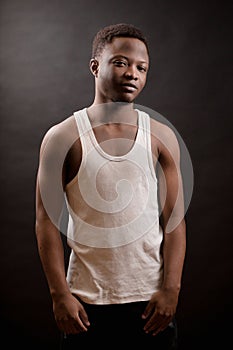 Africanamerican young male with athletic body isolated on the black background photo