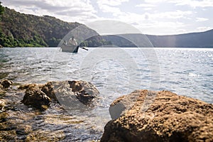 Africans in canoe on beautiful Chala lake, Kenya and Tanzania bo