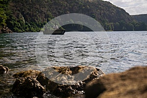 Africans in canoe on beautiful Chala lake, Kenya and Tanzania bo