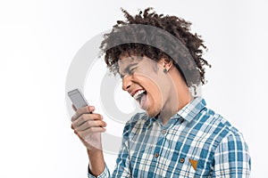 Afro amerian man shouting on smartphone