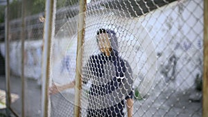 Afro-american boy behind fence, migrant child separated from family, detained photo