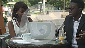 Afro-American business team argue during business meeting in cafe