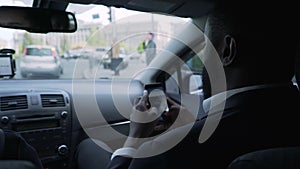 Afro-American businessman going to meeting, looking through questions on phone