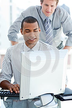 Afro-american businessman working at a computer