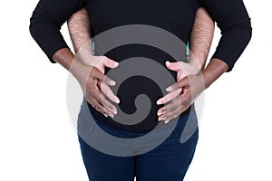 Afro American couple hands on pregnant belly black woman and white man