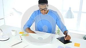 Afro-American Creative Designer Working with Graphic tablet on Laptop