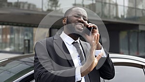 Afro-American diplomat negotiating by phone, defending his interests and opinion photo