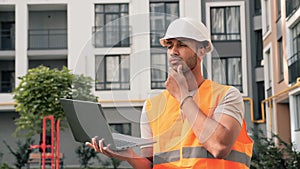 Afro american engineer looking away thoughtfully think about project solution.