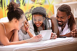 Afro-American family with children in bedroom