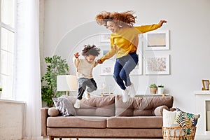 Afro american family mom and son having fun in living room at home