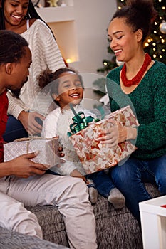 Afro American family opening present on Christmas