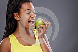 Afro-American female biting apple