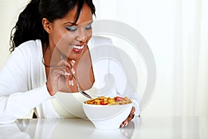 Afro-american female eating a bowl of cereals