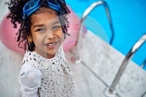 Afro-American Girl\'s Delight with Dive Goggles by the Pool