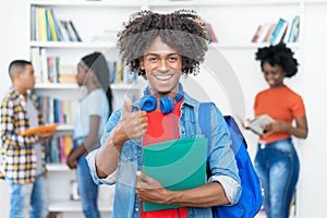 Afro american male college student showing thumb up