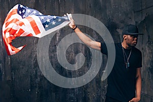 Afro american man hold in hand flying US flag