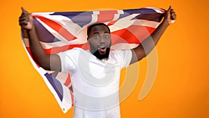 Afro-American man holding British flag, supporting election winner, politic