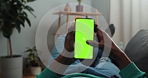 Afro american man scrolling news feed and looking at mock up screen with trecking markers. Guy using mobile phone and