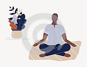 Afro-american man sitting with his legs crossed on floor and meditating. Young guy in yoga posture doing meditation, mindfulness