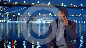 Afro-American man standing at Brooklyn Bridge New York at night - street photography