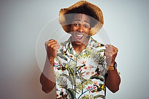 Afro american man on vacation wearing summer shirt and hat over isolated white background celebrating surprised and amazed for