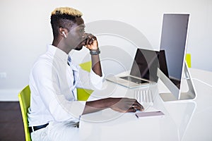 Afro american man working in call center. Manager with computer. Man on workplace. Consultant with microphone. Customer service