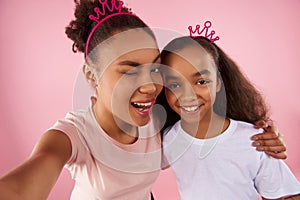 Afro American mother and daughter in sham crowns