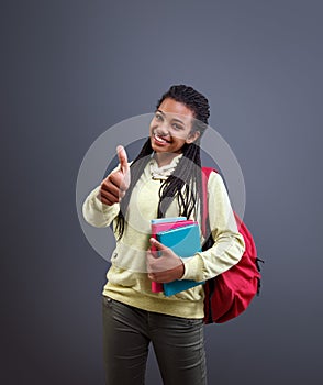 Afro-American school child show thumb up for beginning school year